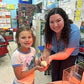 Teacher helping a student hold a newly hatched chick